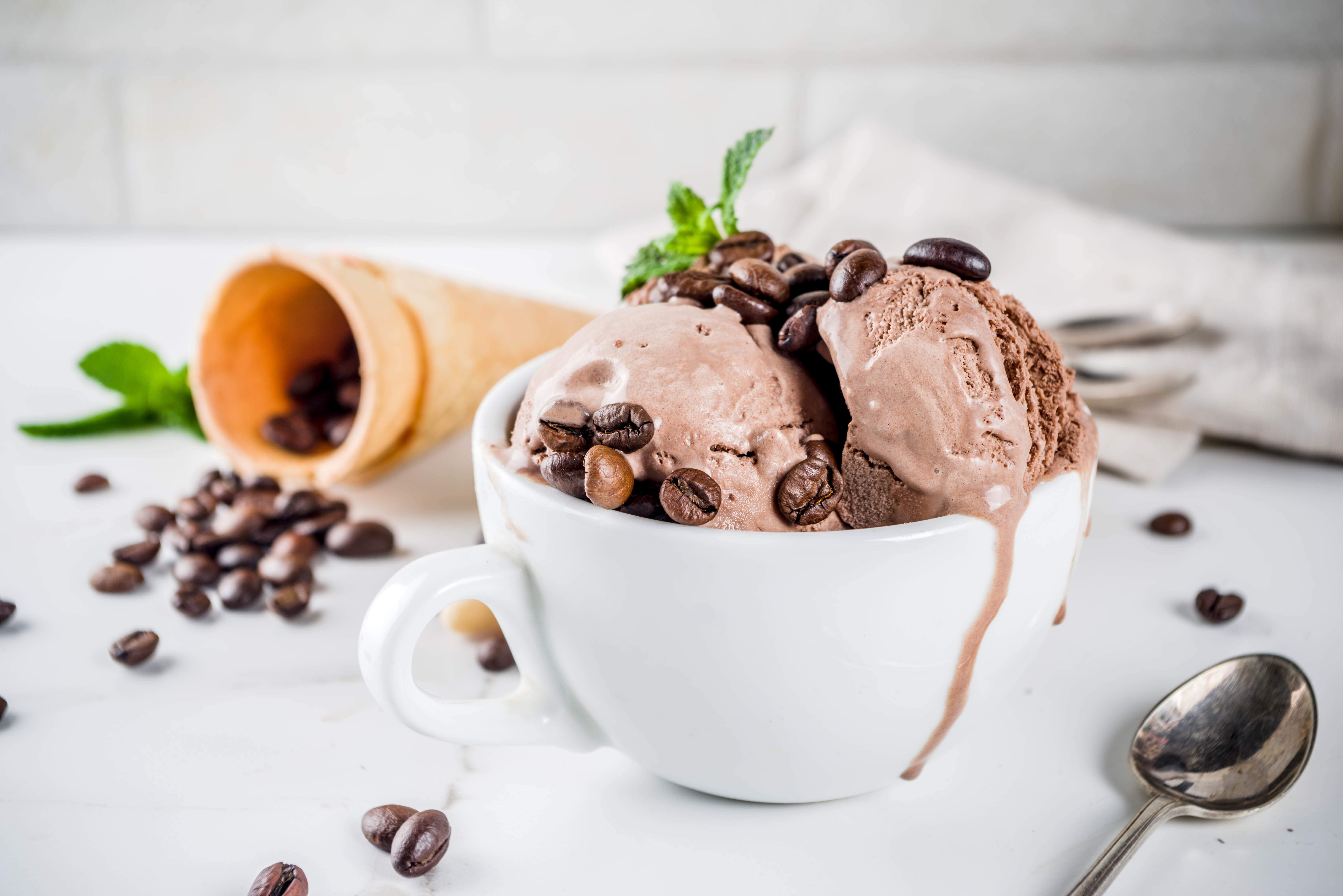 Homemade Coffee Ice Cream Served With Coffee Beans And Mint Leaves